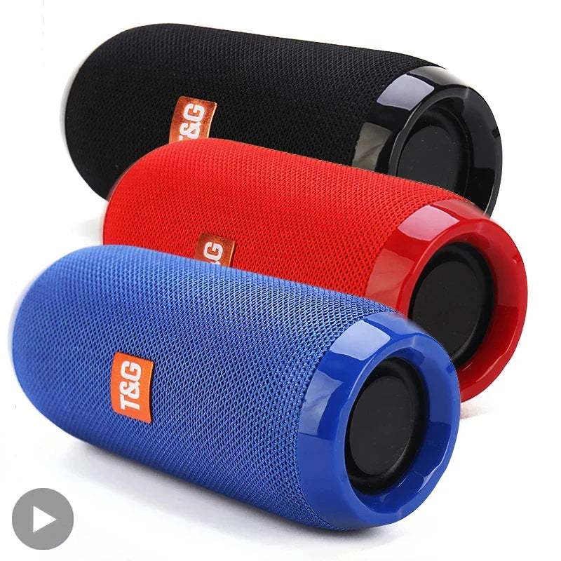 Three wireless portable bluetooth speakers in black red and blue with fabric bodies and radio fm subwoofer audio hand free features