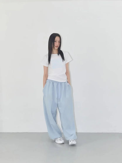 Light blue wide-leg joggers with drawstring waistband designed for casual street dance and athletic use