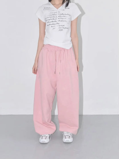 Soft pink wide-leg sweatpants with drawstring waistband designed for casual street dance and athletic wear