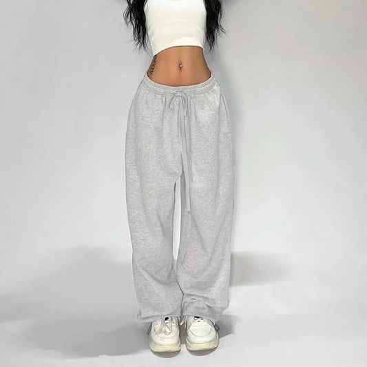 Woman american hip hop wide leg joggers in gray heathered fabric with drawstring waistband and loose tapered legs