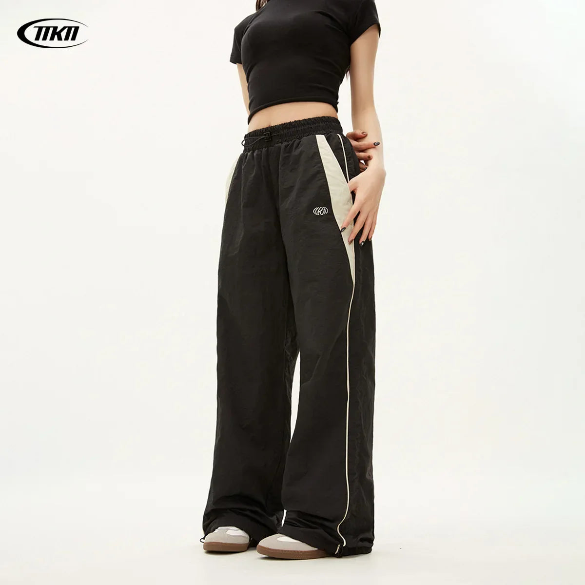 Black tiki brand women casual joggers with oversized sports wide-leg fit, white side stripes, and hip hop y2k style