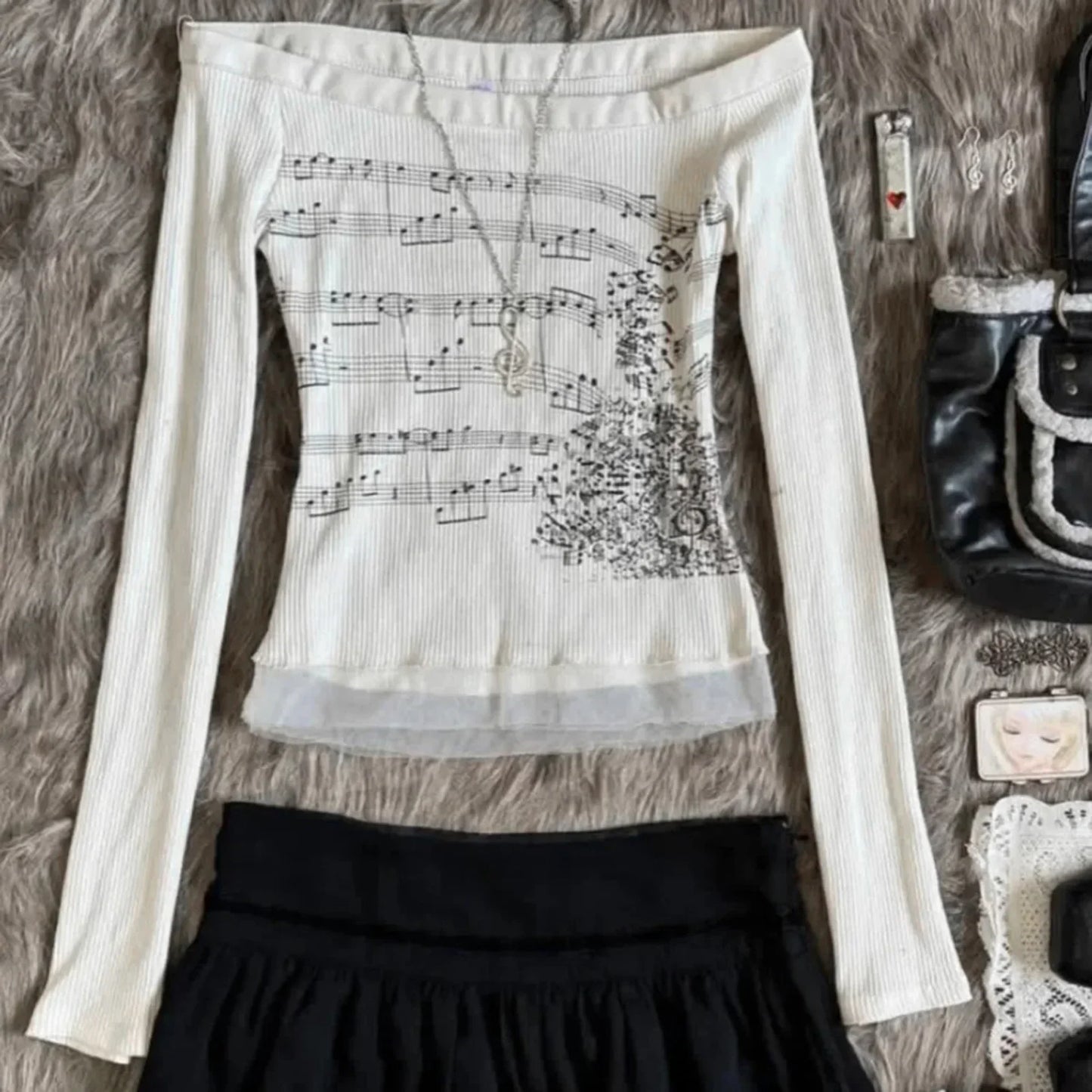 Off-the-shoulder cream ribbed knit top with black music note print and floral embroidery boat neck music patchwork slim fit