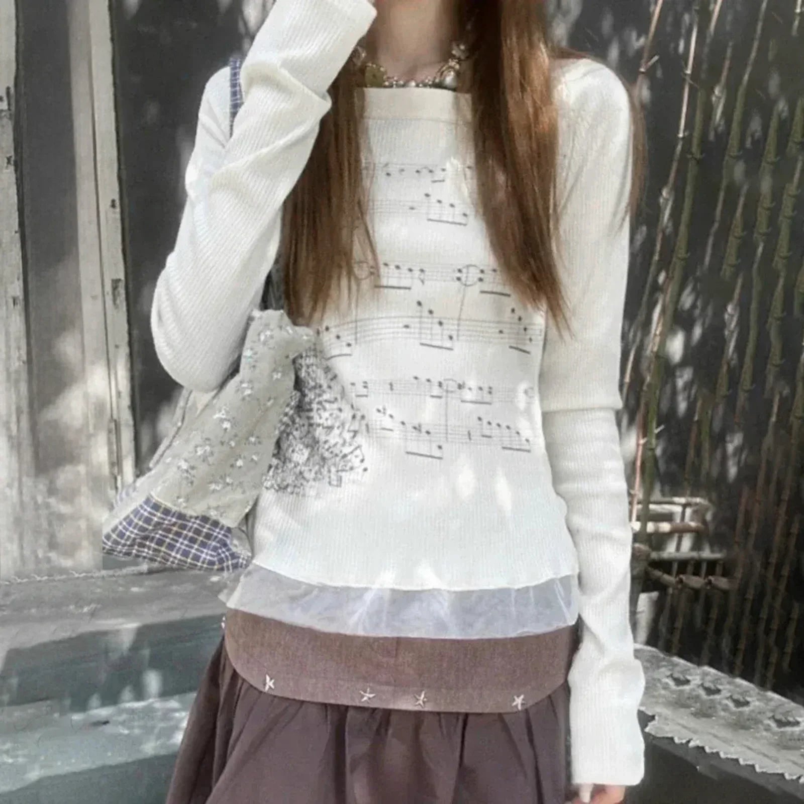 White knit women t-shirt with boat neck music note print patchwork slim fit and sheer ruffled hem design
