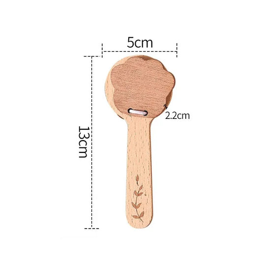 Light brown wooden baby musical spoon toy with carved leaf design and metal loop for instruments sensory rattle use