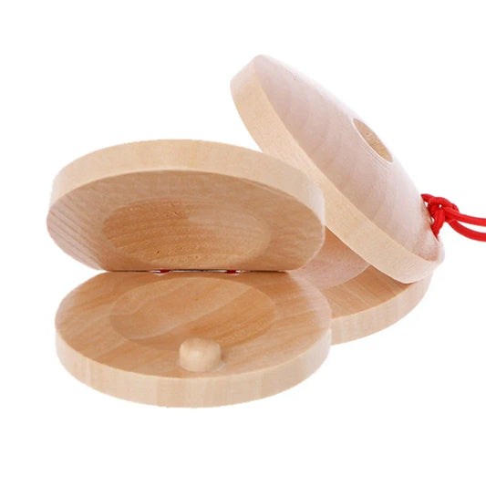 Light-colored wooden castanets wood percussion flamenco musical instrument kids toy with red string attached