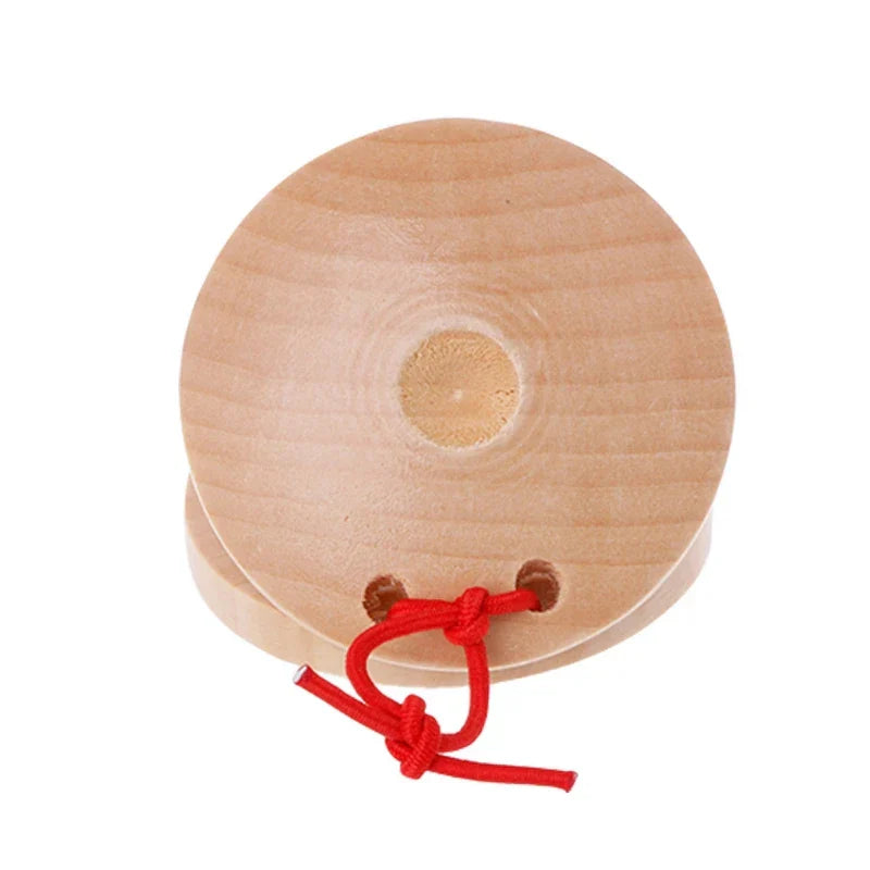 Light-colored wooden castanets wood percussion flamenco musical instrument for kids with red string tied through holes