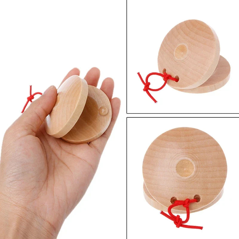 Light-colored wooden castanets wood with red string ties percussion flamenco musical instrument kids toy
