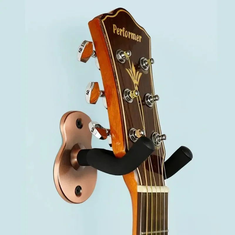 Copper-colored wooden guitar wall mount hanger heavy duty with black padded arms holding acoustic guitar headstock