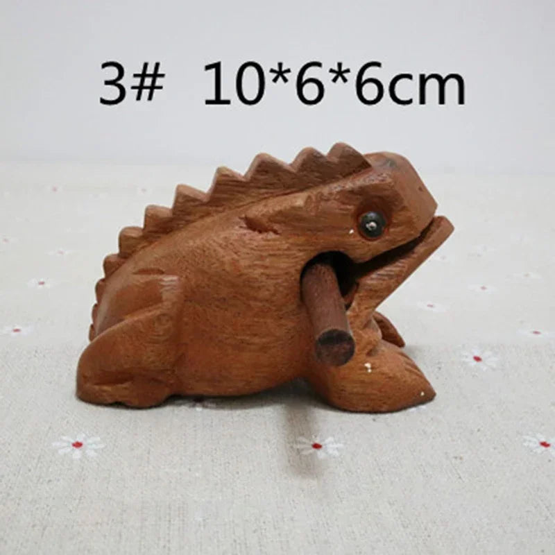 Brown wooden lucky frog croaking musical instrument with metal eye and cylindrical handle for home decor and gifts