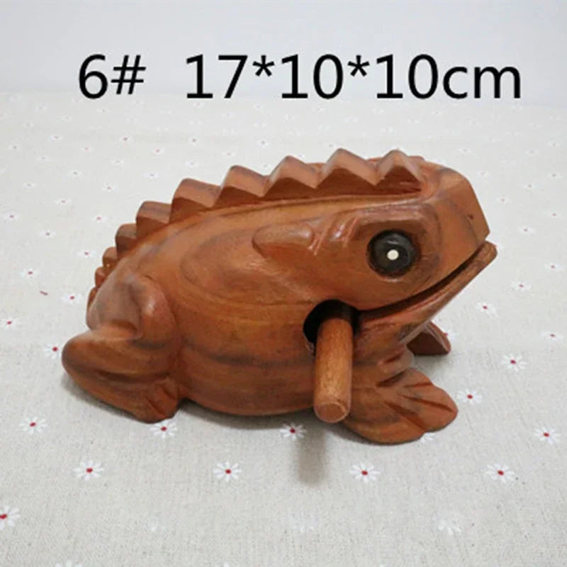 Hand carved wooden lucky frog with smooth warm brown finish and detailed ridges traditional croaking musical instrument