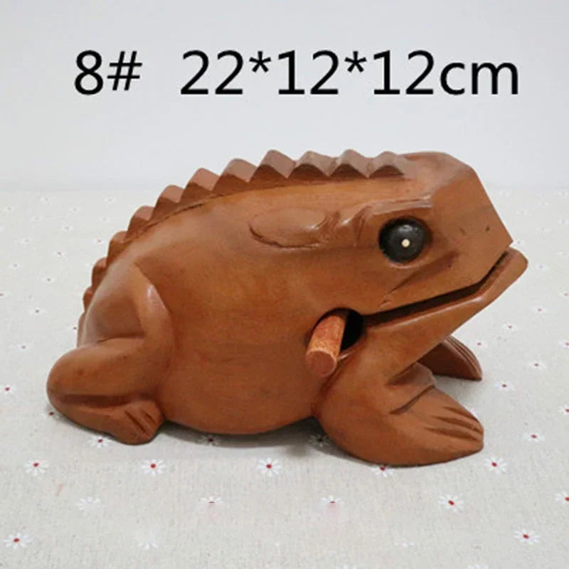 Brown wooden lucky frog figurine with black eye and textured back croaking musical instrument and fengshui decor