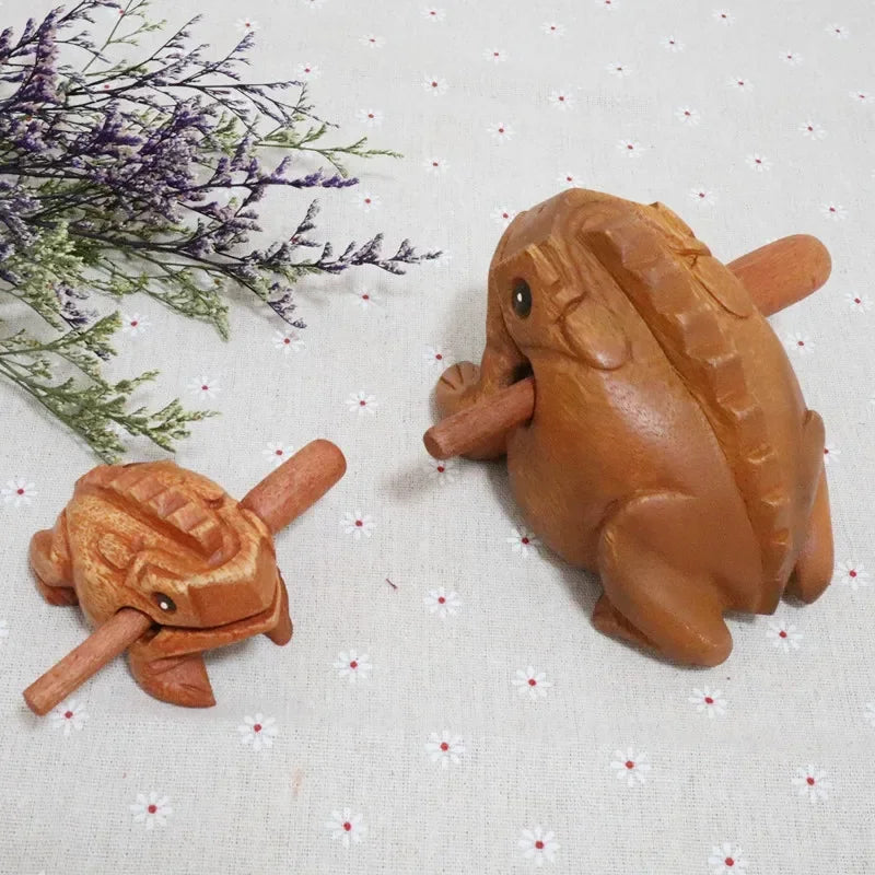 Hand-carved wooden lucky frog nutcrackers in warm brown finish with croaking musical instrument feature for fengshui decor