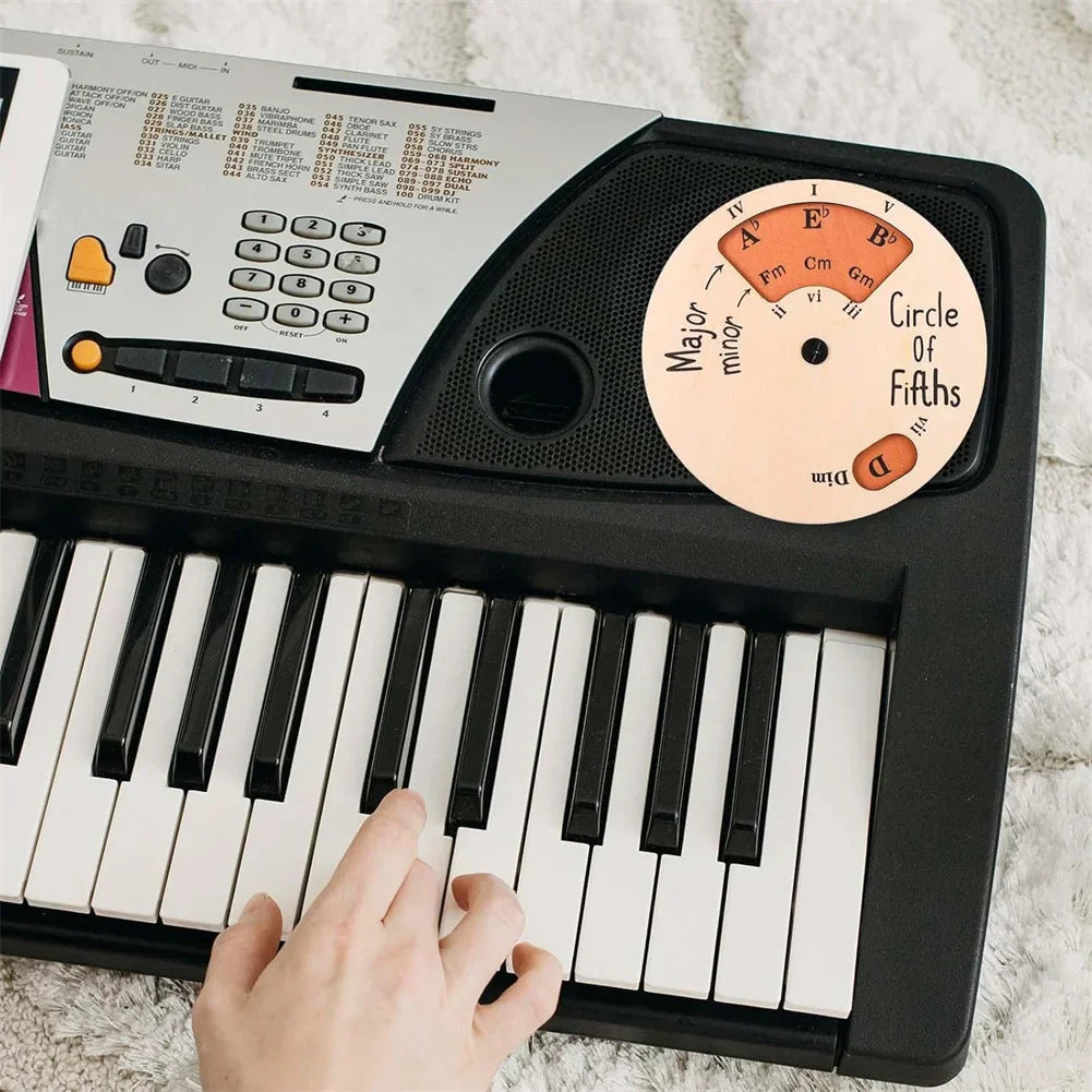 Black and silver electronic keyboard with circular fifths wheel melody sticker for tool music transpose and melody chord tool use