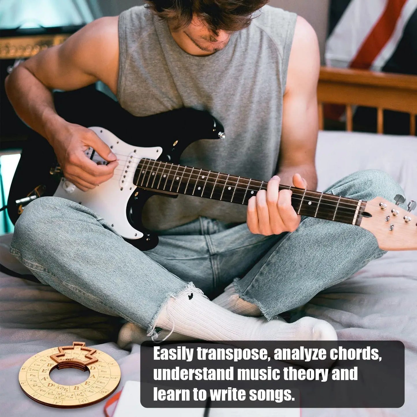 Black and white electric guitar with glossy finish alongside a wooden fifths wheel melody chord tool music transpose accessory