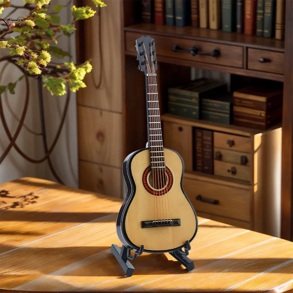 Wooden miniature guitar with light wood body and black binding on stand for musical ornaments craft home decor