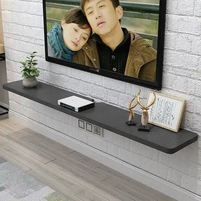 Black wooden modern tv stand with matte finish and integrated power outlets for suspended minimalist stands bedroom