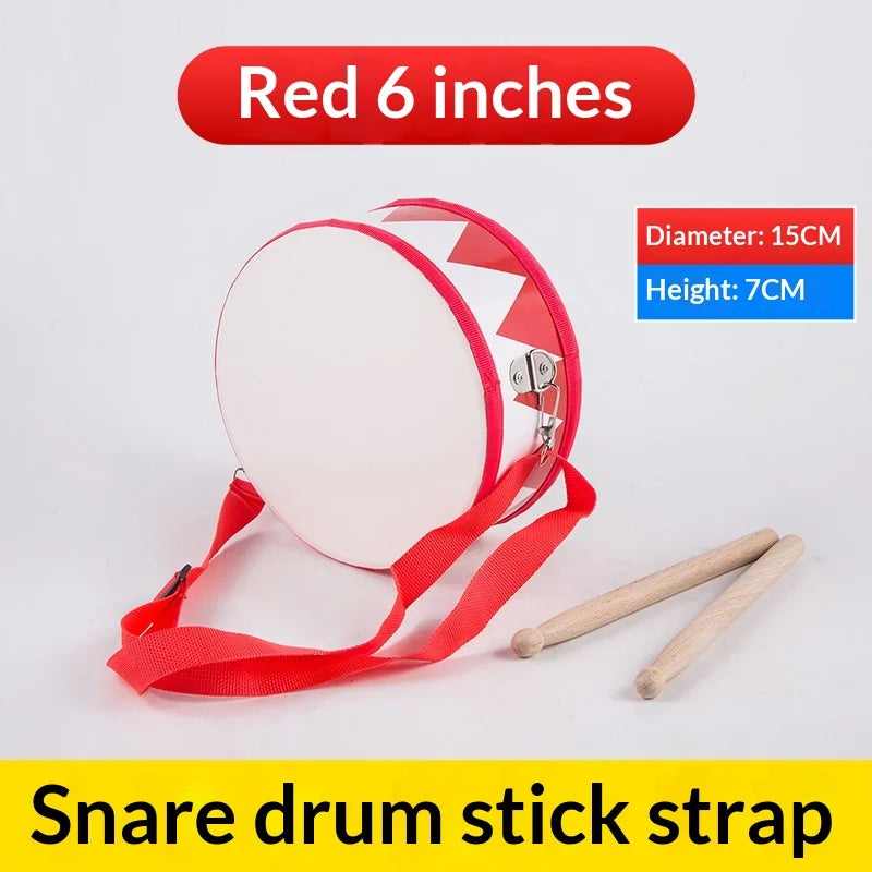 Red 6-inch wooden percussion snare drum toy with white head, red trim, and carry strap for toddlers rhythm development