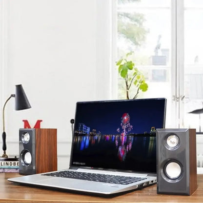 A pair of wooden wired loudspeakers with wood finish silver accents and dual drivers for computer and smartphone use