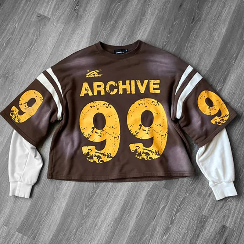 Brown cropped sweatshirt with distressed yellow 99 and archive lettering white sleeve stripes over white inner layer