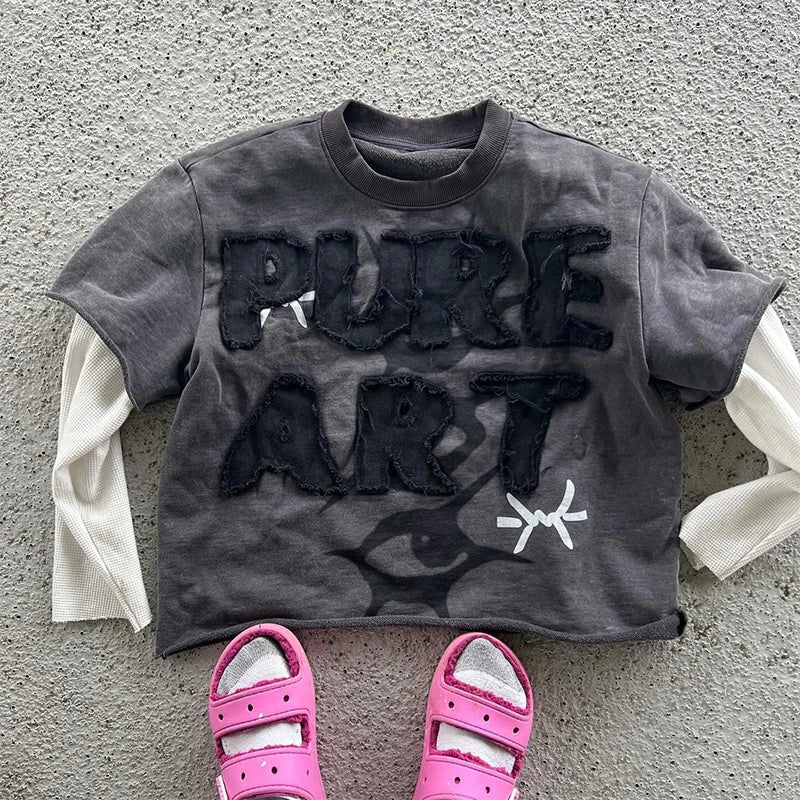 Dark gray cropped sweatshirt with pure art frayed lettering and white bow detail in a y2k printed graphic hoodie style