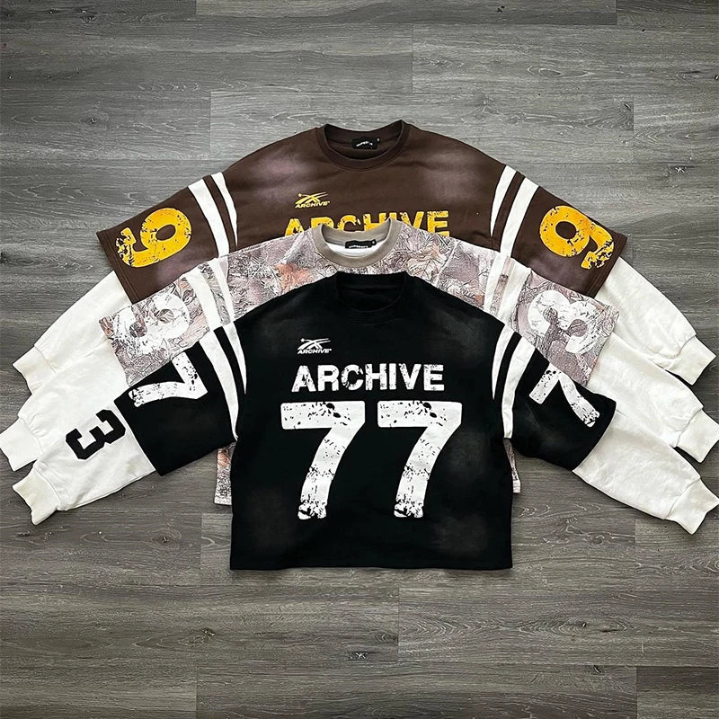 Black sweatshirt with distressed white 77 and archive text and camouflage sleeve panel in casual hip hop style