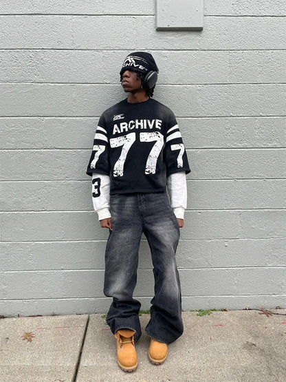 Black long sleeve sweatshirt with white archive 777 graphic and striped sleeves in casual loose hip hop style