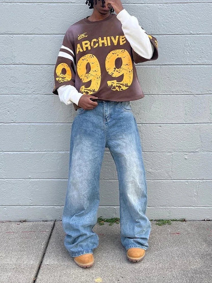 Brown oversized sweatshirt with yellow archive 99 graphic and white sleeve stripes in a casual hip hop style