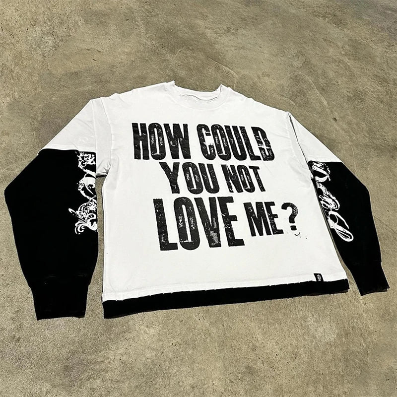 White long sleeve printed graphic t shirt with black sleeves and hem featuring bold distressed text and floral embroidery