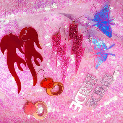 Pink glitter lightning bolt y2k earrings featuring cute flame snake and lightning queen alien design for women
