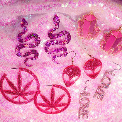 Pink glittery resin y2k earrings featuring cute flame snake design with shimmering lightning queen alien finish