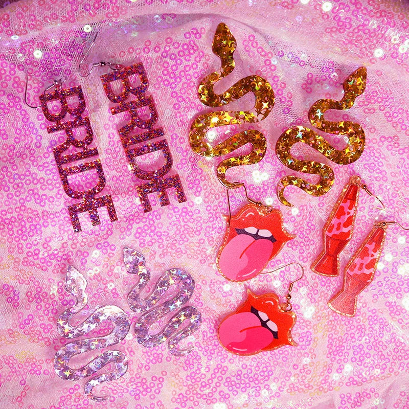 Glittery gold y2k earrings featuring cute flame snake design with star-shaped sequins for lightning queen alien style