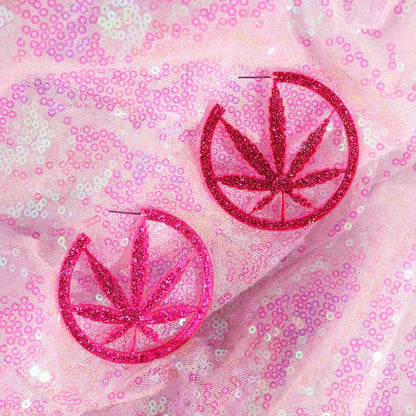 Pink glittery y2k earrings featuring a circular cannabis leaf design for cute flame snake lightning queen alien styles