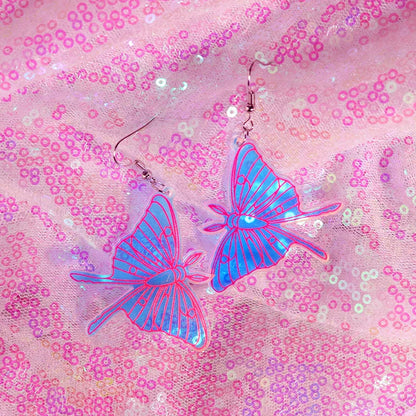 Transparent blue y2k earrings with pink outlines and metallic hooks featuring cute flame snake and lightning queen alien design