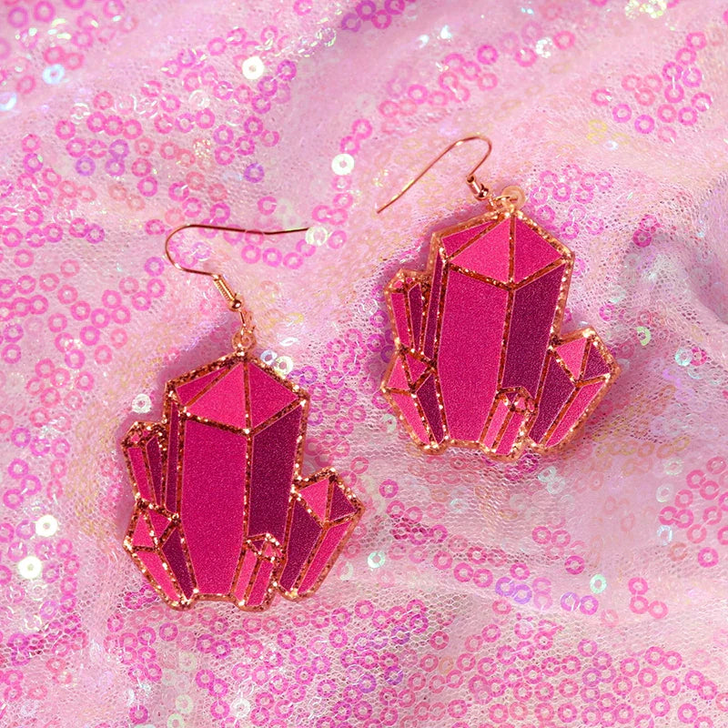 Vibrant fuchsia y2k earrings shaped like crystals with rose gold outlines featuring cute flame snake and lightning queen alien designs