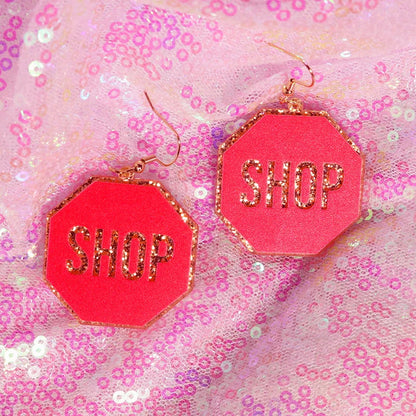 Bright pink y2k earrings with gold glitter shop lettering and rose gold hooks in cute flame snake lightning queen alien style