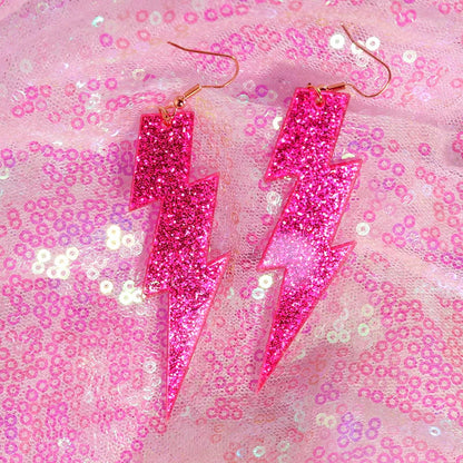 Vibrant pink glitter lightning bolt y2k earrings with gold-toned hooks from cute flame snake lightning queen alien set