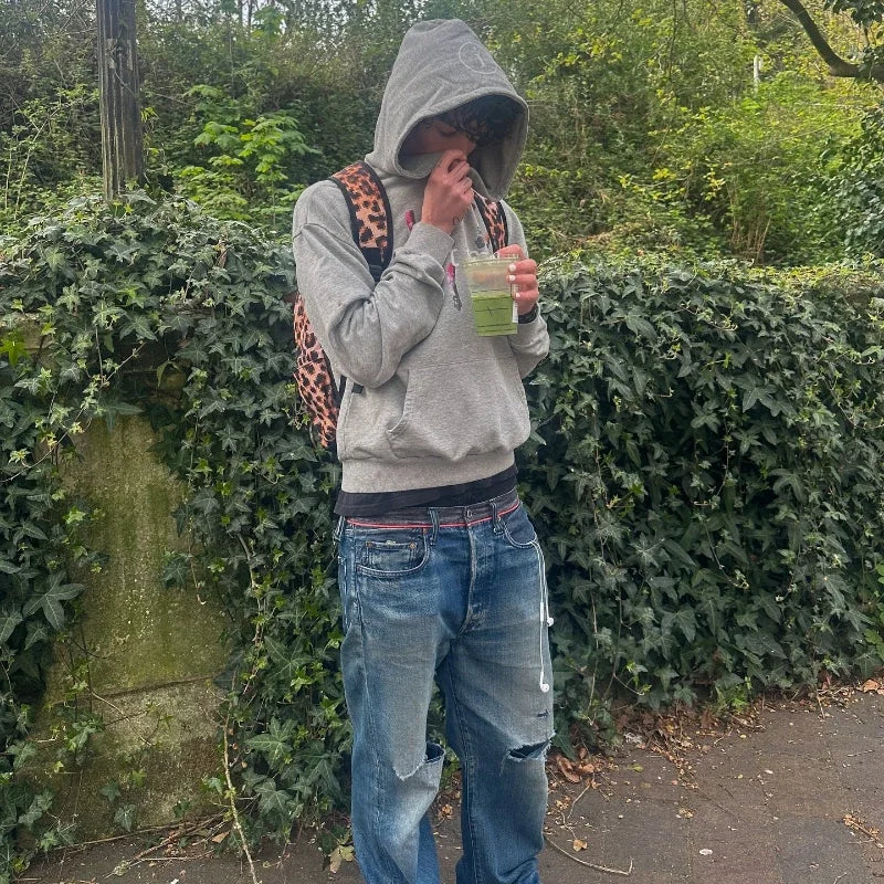 Y2k gray sports hoodie with a retro smoke print and leopard-print backpack strap visible over the shoulder