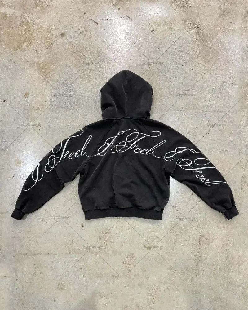 Back view of black y2k harajuku gothic oversized zipper sweatshirt with white cursive i feel i feel lettering on back and sleeves