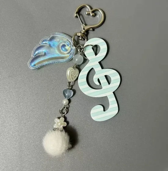 A y2k harajuku musical heart pendant necklace keychain with silver clasp blue wing charm and mint green chain