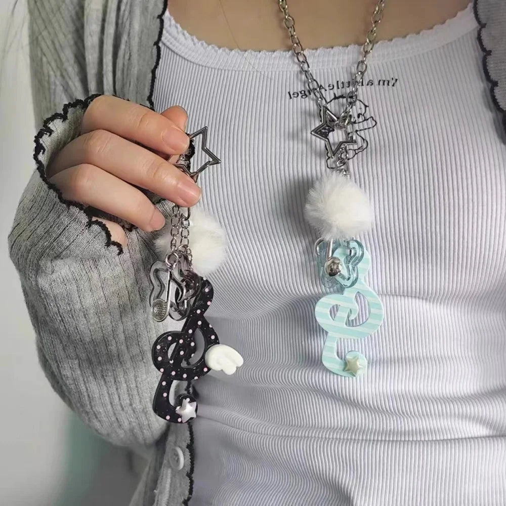 Black and white polka-dotted y2k harajuku musical keychain with fluffy pom-pom accent for korean trendy chain use