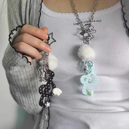 Black and white polka-dotted y2k harajuku musical keychain with fluffy pom-pom accent for korean trendy chain use