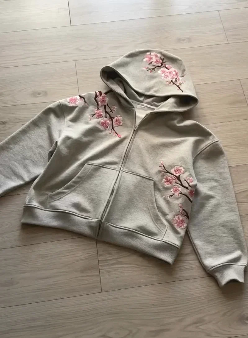 A soft gray y2k vintage oversized embroidered hooded jacket with pink cherry blossom detailing on shoulders and sleeves