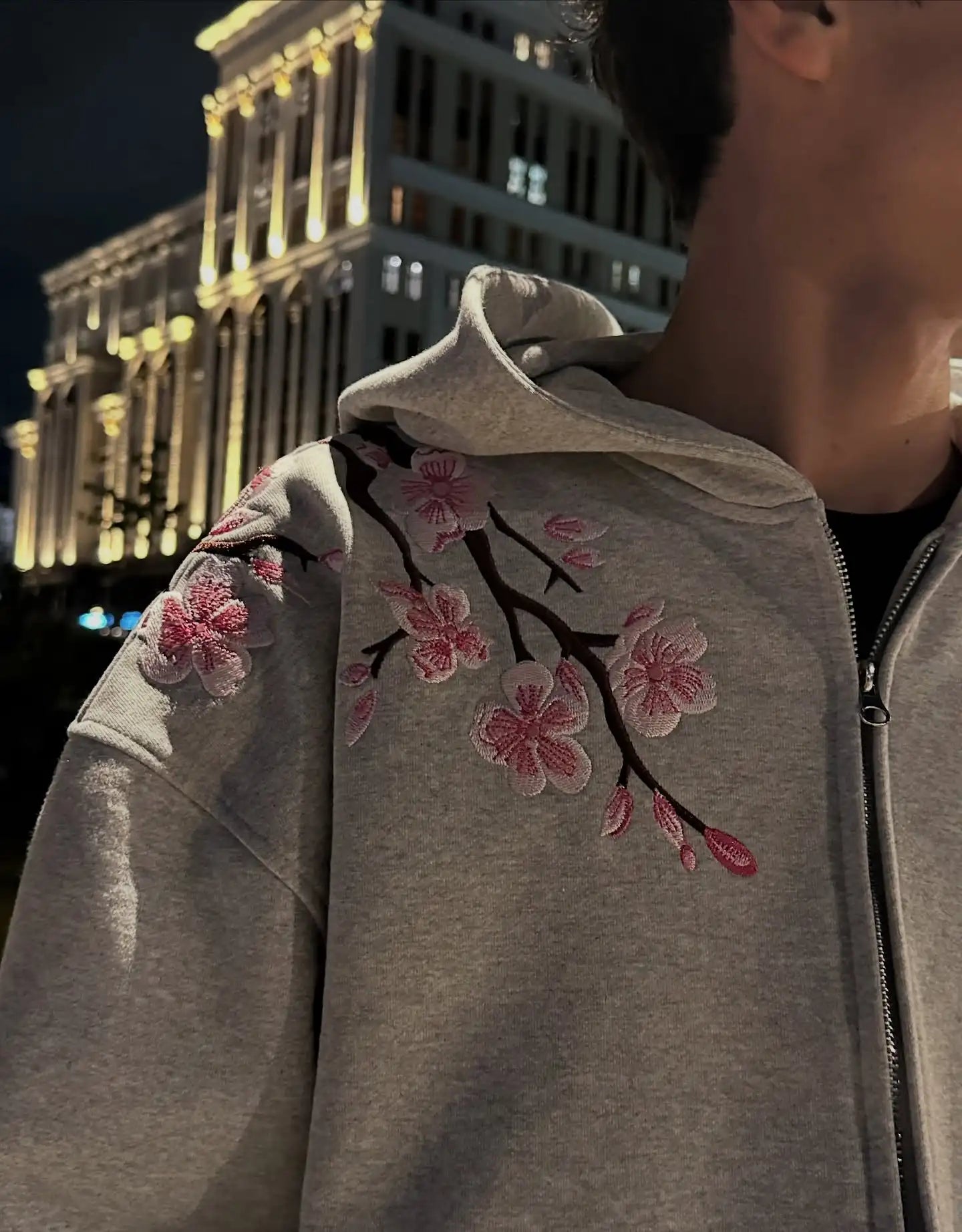 A gray y2k vintage oversized embroidered hooded jacket with pink cherry blossom embroidery on shoulder and sleeve