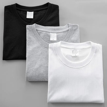 Three neatly folded Yeat 2026 album ADL graphic crew neck t-shirts in black heather gray and white cotton for summer