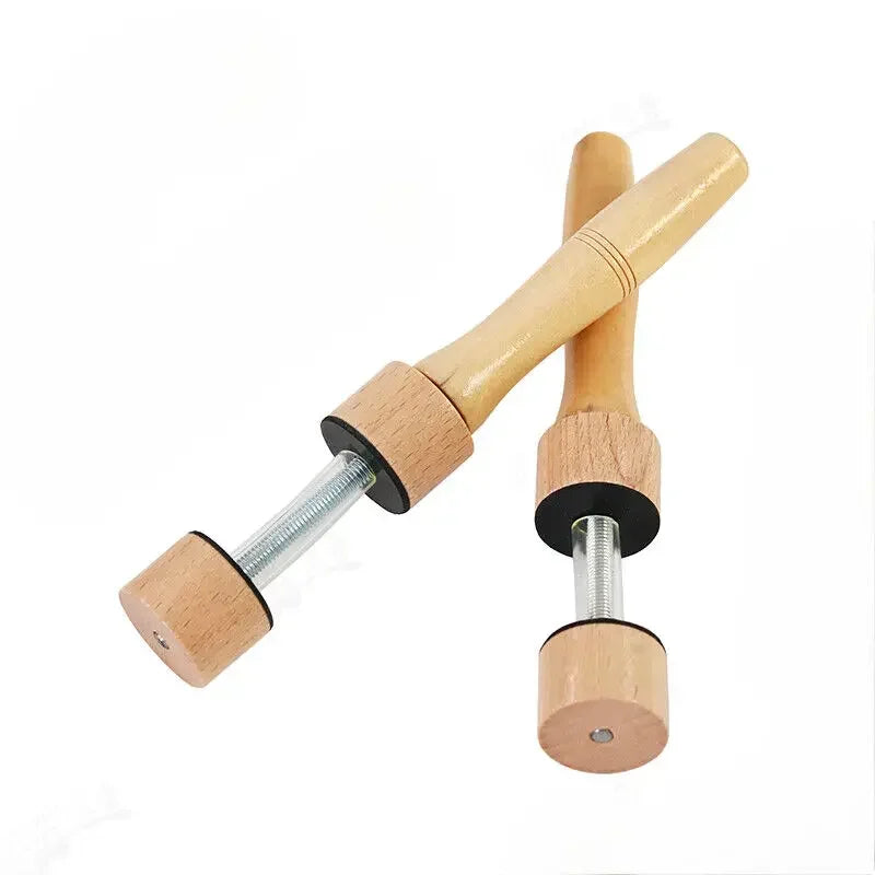 Light-colored wooden dumbbell with metal threaded shaft and black rubberized ends for closure jig violin making tools