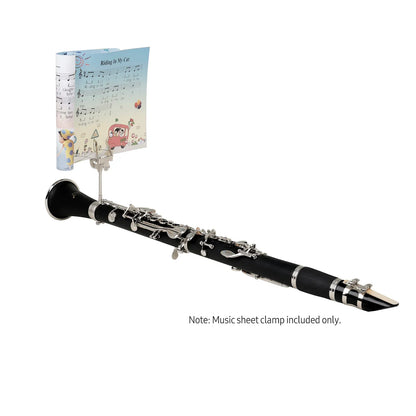 Black clarinet with silver keys and colorful sheet held by a silver iron trumpet marching lyre portable music stand clamp
