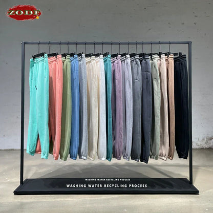 A rack of zodf trendy men 345gsm fleece sweatpants in solid colors featuring retro hip hop style joggers